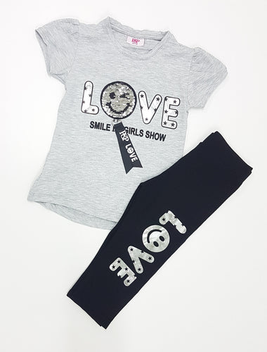 Grey top with silver smiley face and black trouser